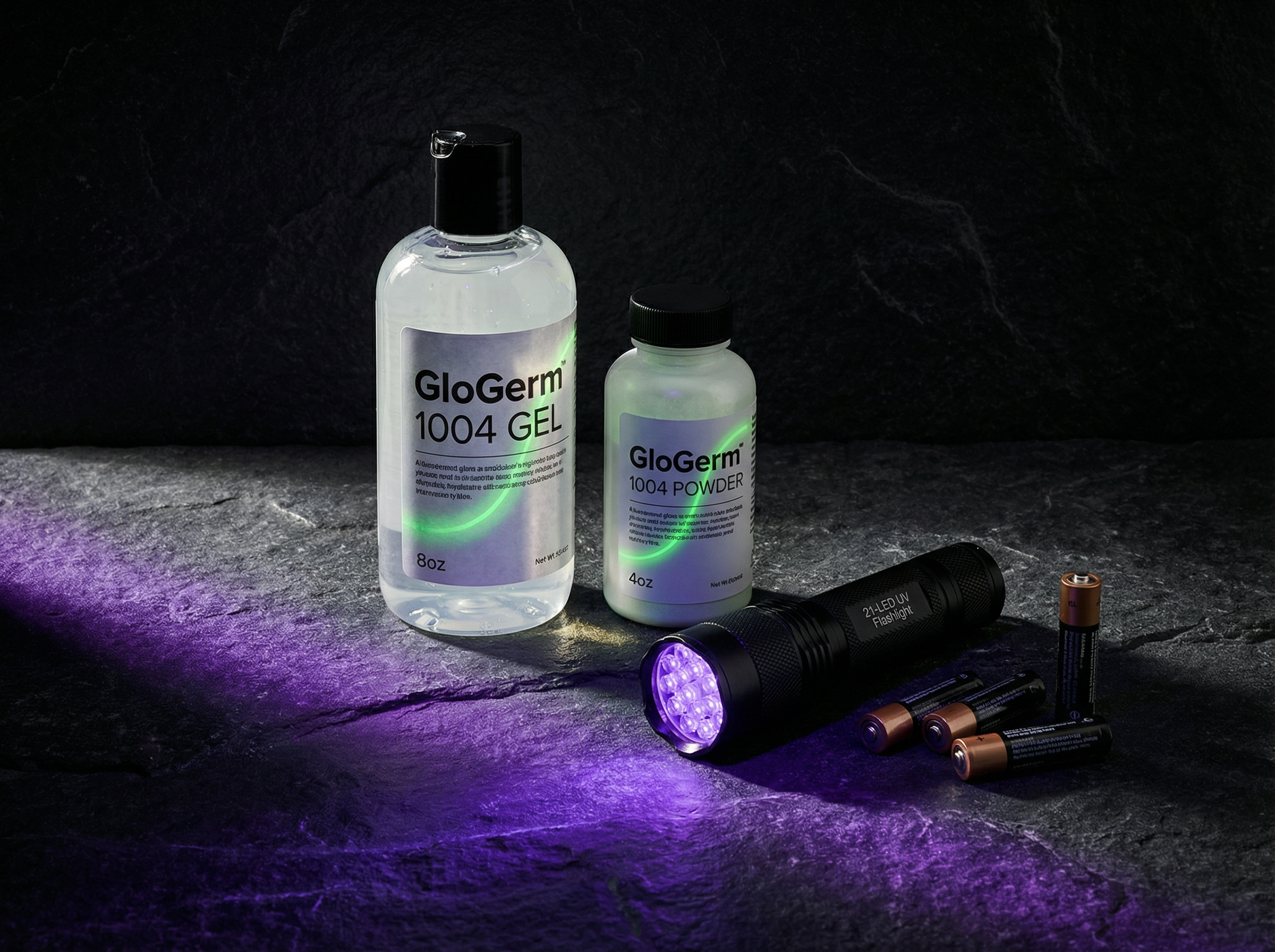 GloGerm Kit 1004 with gel bottle, powder, and UV flashlight on dark surface
