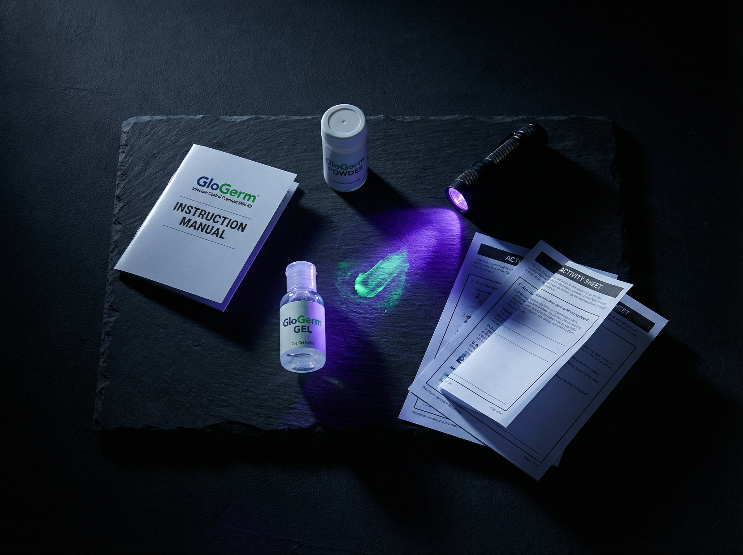 GloGerm Premium Mini Kit flat lay with UV flashlight, gel, powder and instruction manual
